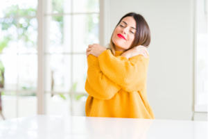 self-care, woman hugging herself